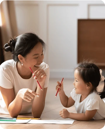 Caregiver drawing and learning with a child