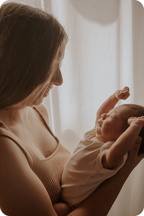 Loving caregiver holding and soothing a newborn